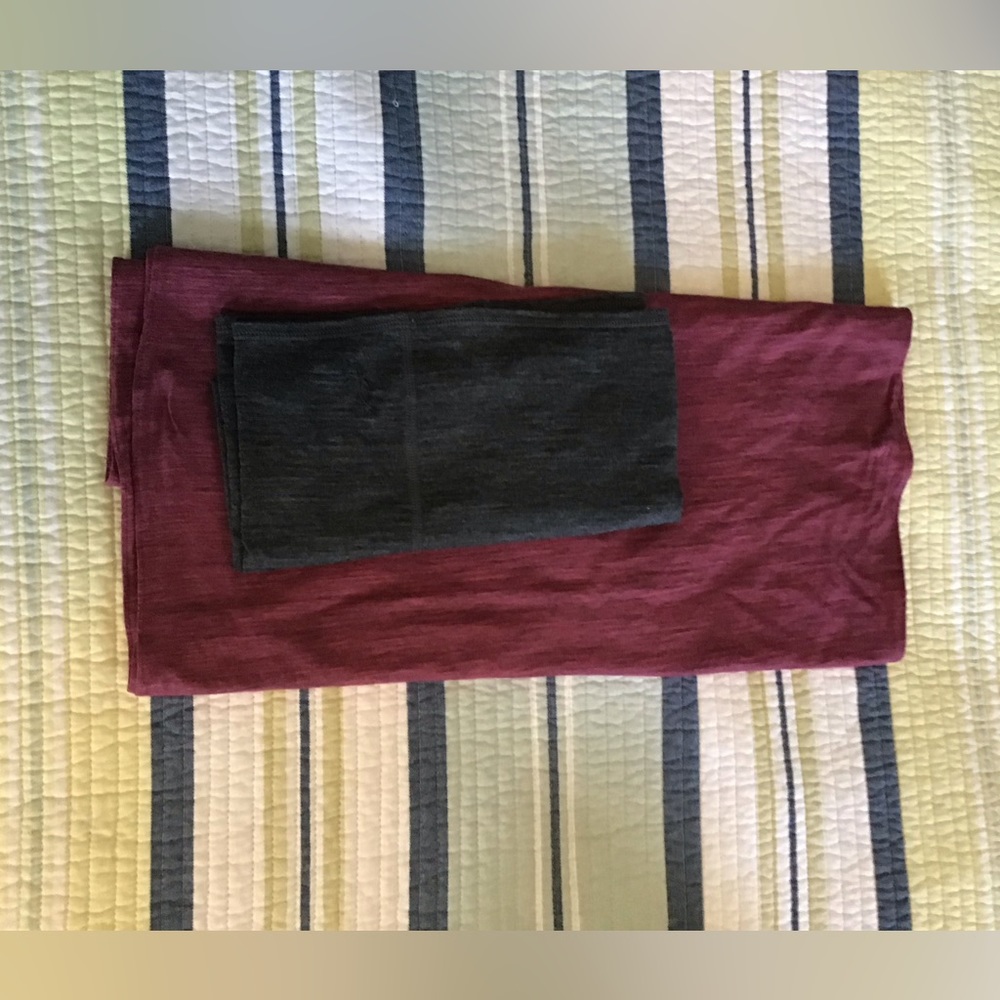 One pink Ibex merino wool  infinity scarf and merino wool buff in charcoal gray.